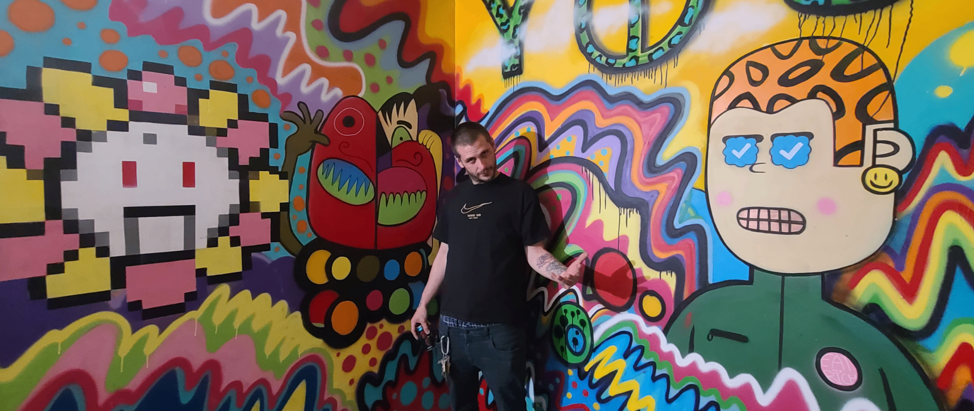 Fun House Garage mural — character detail with visitor