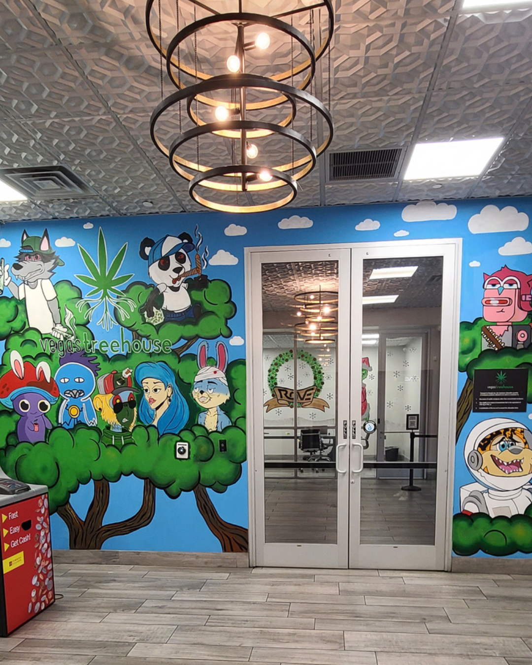 Vegas Tree House dispensary lobby mural — full front wall with signature NFT characters