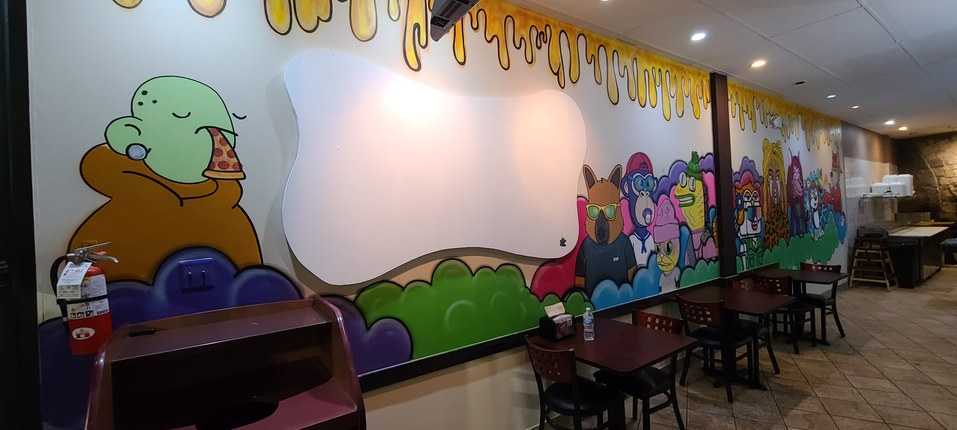 Stone Hot Pizza mural — left side view with pizza-eating character and dripping cheese typography